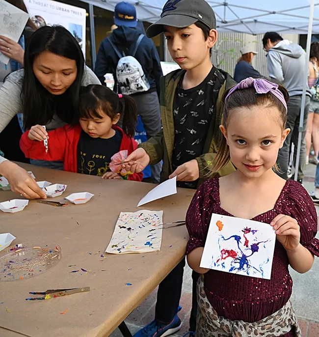 Winter Owens, 5, of Carmichael, displays her Maggot Art masterpiece. (Photo by Kathy Keatley Garvey)