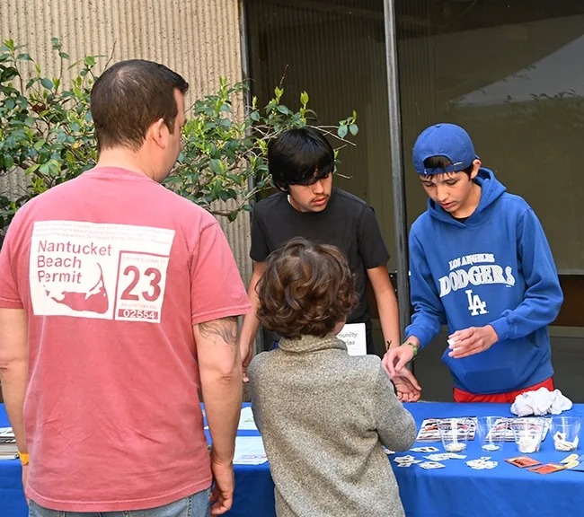 Diego Rojas (left) and his brother, Spencer Rojas, offered information about invasive pests as they gave away stick-on (temporary) tattoos. Their mother, Karey Windbiel-Rojas, a UC IPM administrator, was at an adjacent table. (Photo by Kathy Keatley Garvey)