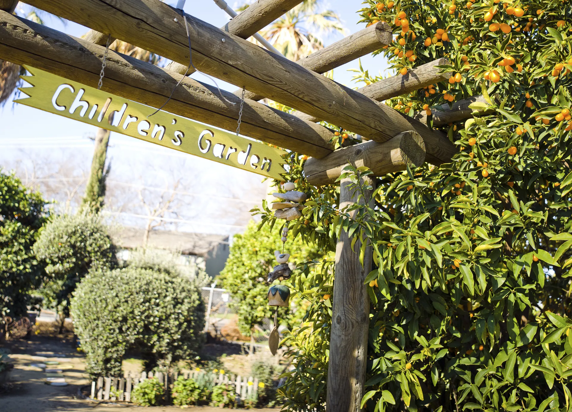 Children's Garden sign hanging in a garden