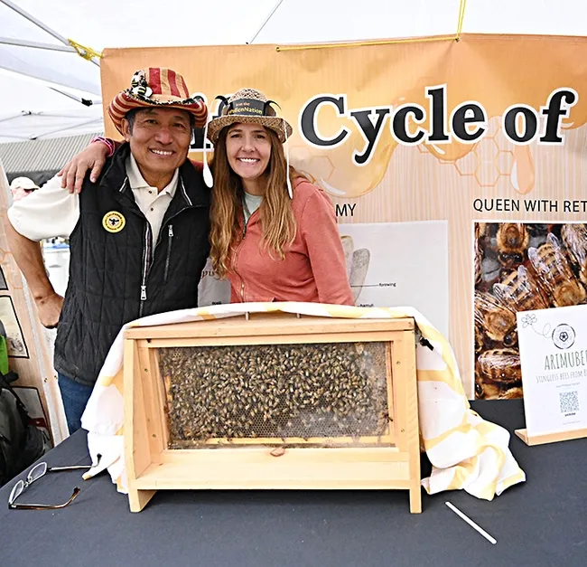 Master Beekeeper Sung Lee of Castro Valley, known worldwide on social media as "Sung Lee The Bee Charmer," displayed his observation hive at the California Honey Festival. With him is fellow CAMBP member Leandra Hale of Lake Tahoe. (Photo by Kathy Keatley Garvey)