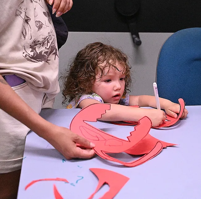 Esmeralda Myhre, 2, works on her art project. Her mother, Morgan Myhre, is a UC Davis senior majoring in entomology. (Photo by Kathy Keatley Garvey)