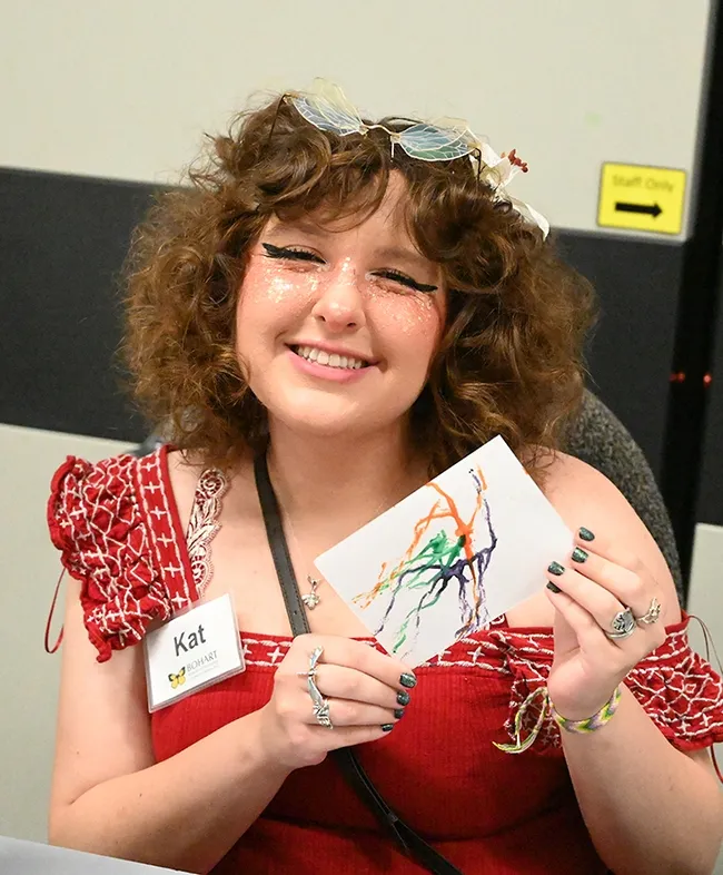 Bohart Museum volunteer Kat Taylor, a UC Davis freshman majoring in entomology, shows her Maggot Art. (Photo by Kathy Keatley Garvey)