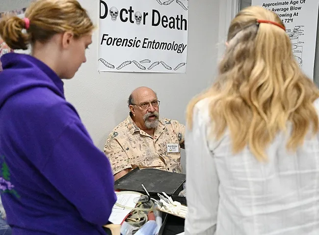 Forensic entomologist Bob Kimsey answering questions at his booth in the Bohart Museum of Entomology. (Photo by Kathy Keatley Garvey)