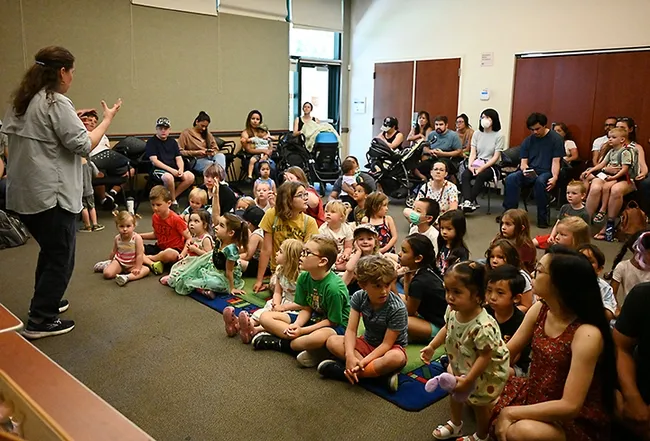 Tabatha Yang, the Bohart Museum of Entomology's education and outreach coordinator, discusses the diversity of insects to a diverse crowd. (Photo by Kathy Keatley Garvey)