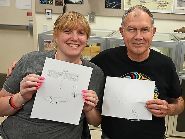 Rosser Garrison and his daughter, Anna Garrison, display their insect drawings. They participated in a class taught at a Bohart Museum of Entomology open house by Professor Miguel Angel Miranda of the University of the Balearic Islands, Spain. (Photo by Kathy Keatley Garvey)
