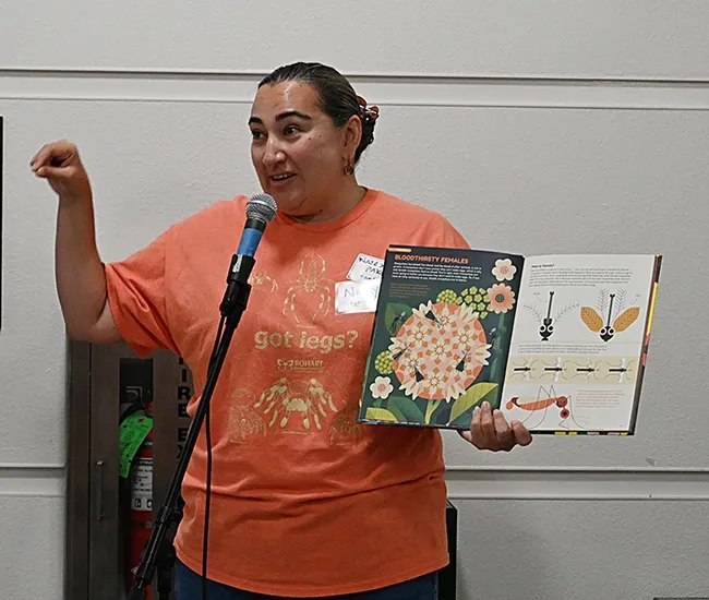 UC Davis alumna Nazzy Pakpour, who holds a doctorate microbiology, virology and parasitology from the University of Pennsylvania, reads from her children's book, "Please Don't Bite Me," at a recent Bohart Museum of Entomology open house. (Photo by Kathy Keatley Garvey)
