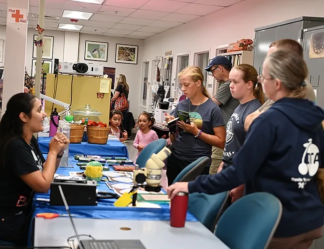 CC Edwards (left), a doctoral student and mosquito research in the lab of UC Davis medical entomologist-geneticist Geoffrey Attardo, answers questions about mosquitoes. (Photo by Kathy Keatley Garvey)