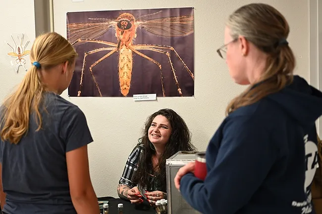 Moriah Garrison, senior entomologist and research coordinator with Carroll-Loye Biological Research (CLBR), showed live ticks and other "household vampires." (Photo by Kathy Keatley Garvey)