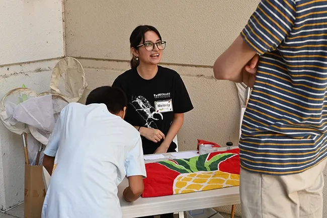 Bohart Museum intern Melody Ruiz, a third-year UC Davis entomology major, staffed the "Clear Packing Tape Art" table. (Photo by Kathy Keatley Garvey)