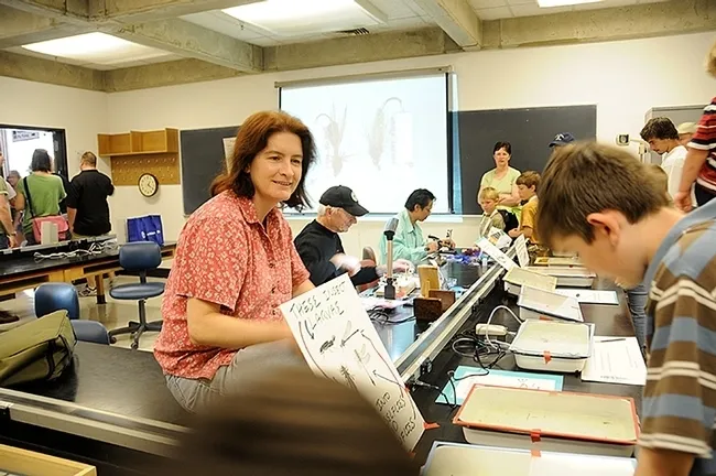 UC Davis Picnic Day celebrants always flock to the aquatic insect displays in Briggs Hall. Here aquatic entomologist Sharon Lawler (at left) engages with the crowd. (Photo by Kathy Keatley Garvey)