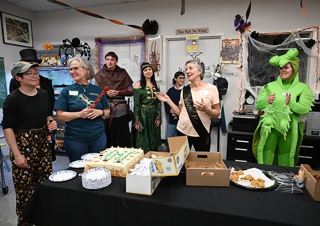 UC Davis distinguished professor Lynn Kimsey (center), director of the Bohart Museum of Entomology, thanks UC Davis biology lab manager and UC Davis alumna Ivana Li (far left), who catered the party. Also pictured (from left) Professor Fran Keller of Folsom Lake College, postdoctoral researcher Severyn Korneyev and his wife, artist Kristina Kernytska, UC Davis alumna Brittany Kohler and Tabatha Yang, Bohart education and outreach coordinator. (Photo by Kathy Keatley Garvey)
