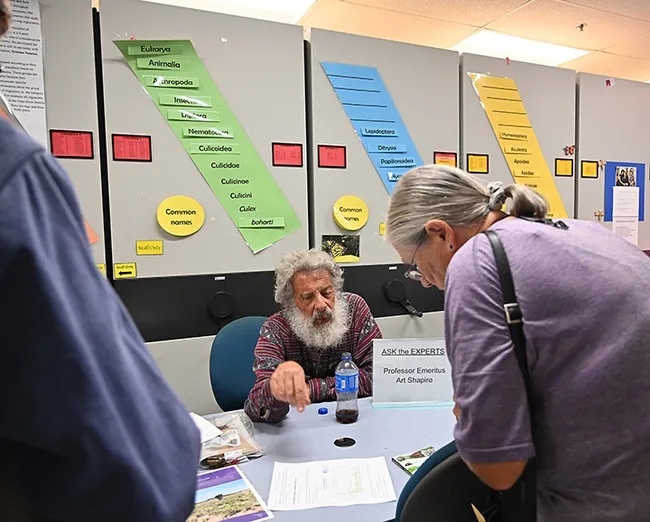 UC Davis emeritus professor Art Shapiro, who has monitored butterfly populations in central California for 50 years, explains his work. (Photo by Kathy Keatley Garvey)