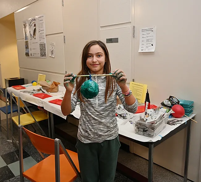 Skylan Potter displays her newly created social wasp nest. (Photo by Kathy Keatley Garvey)