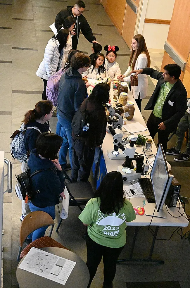 Professor Shahid Siddique and his graduate student Alison Blundell talk to visitors at the UC Davis Biodiversity Museum Day. (Photo by Kathy Keatley Garvey)