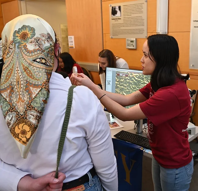 Doctoral student Veronica Casey of Entomology displaying free-living nematode C. elegans, via a microscope and discussing their movements. (Photo by Kathy Keatley Garvey)