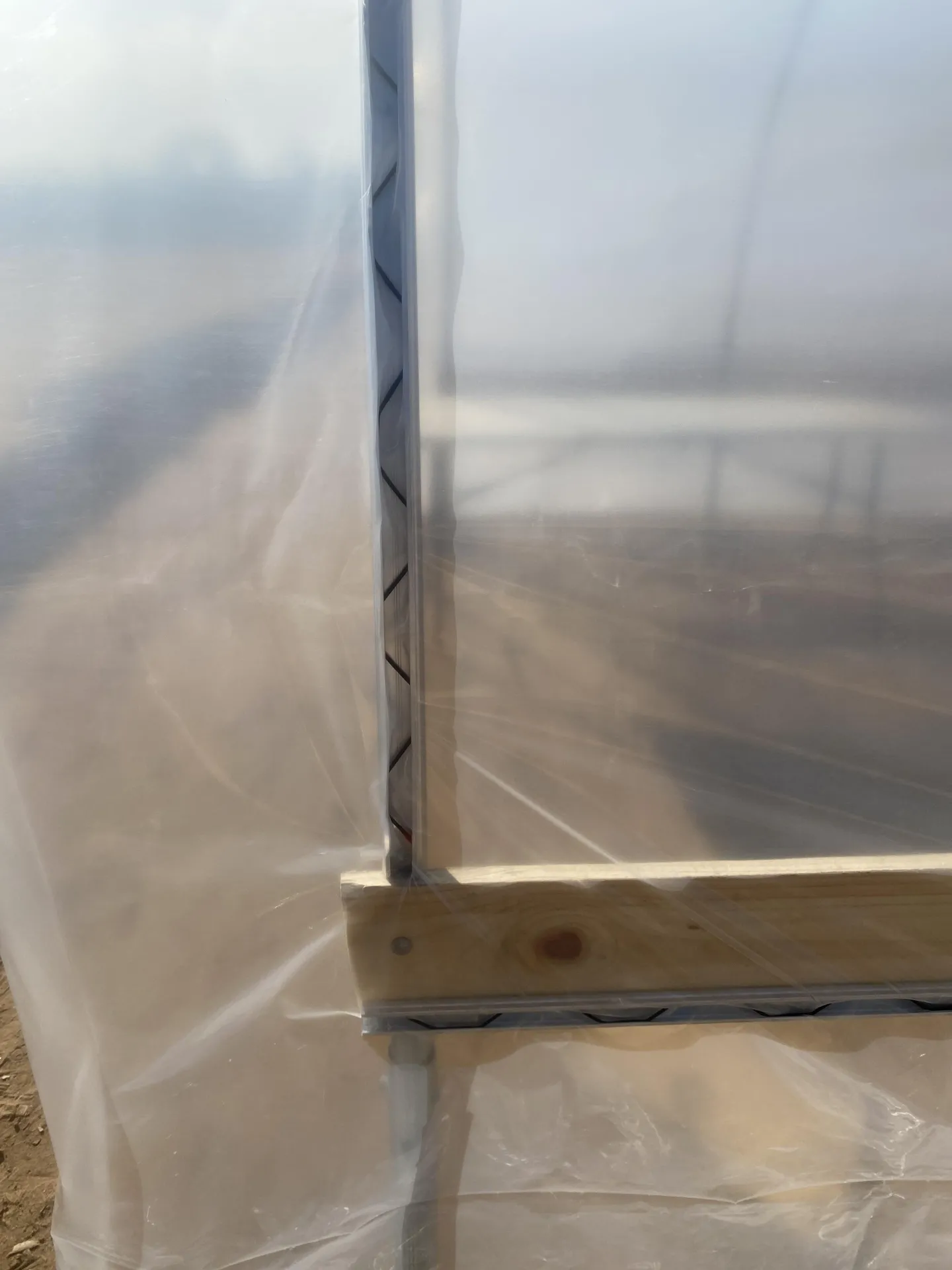 Figure 8. The wiggle wire was used to secure the plastic to the channels on the first and last hoops of the high tunnel and along the hip boards.