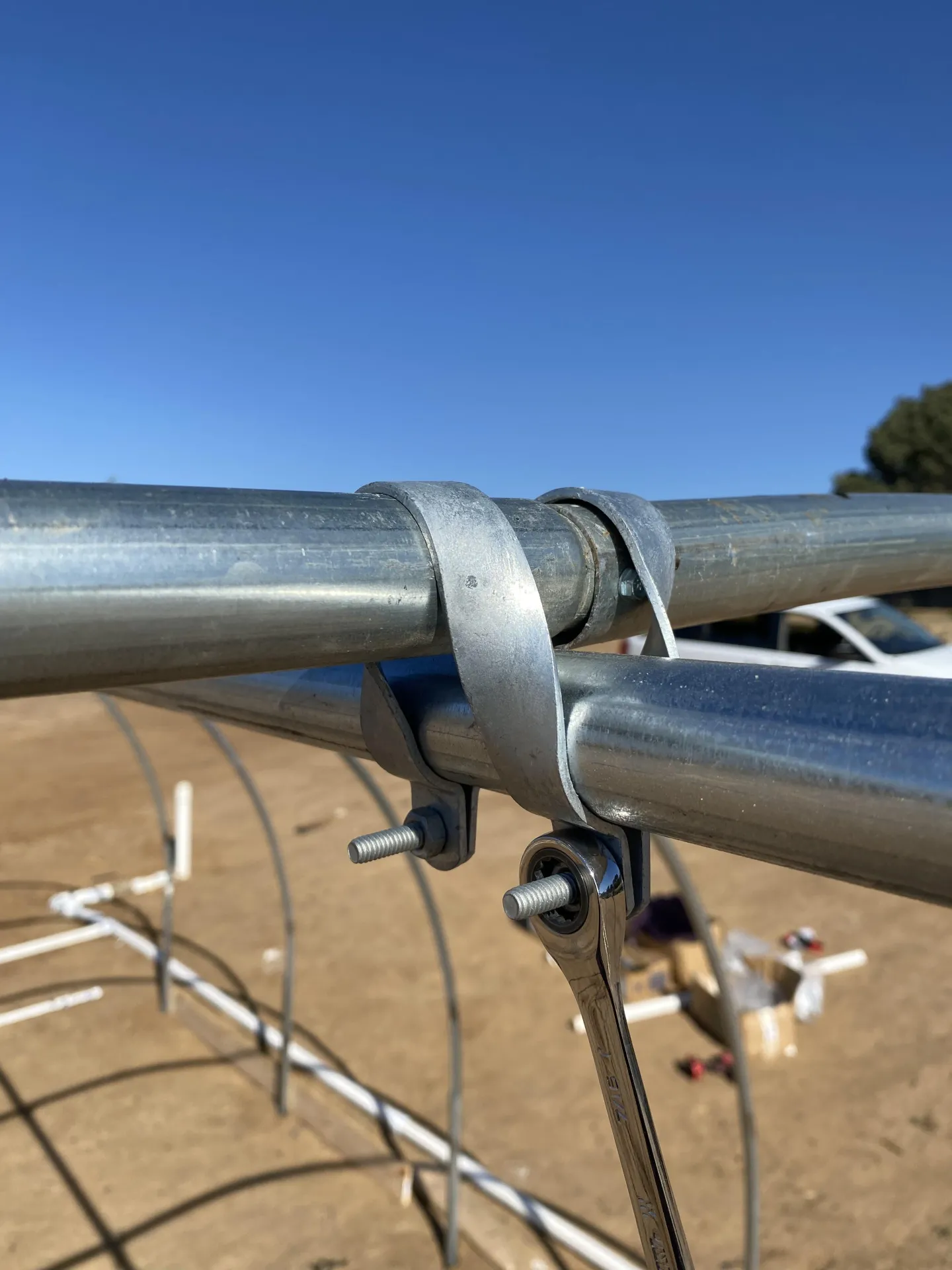 Figure 2. The cross connector should curve over the hoop and hold the ridgepole in place, with the bolts below the ridgepole.