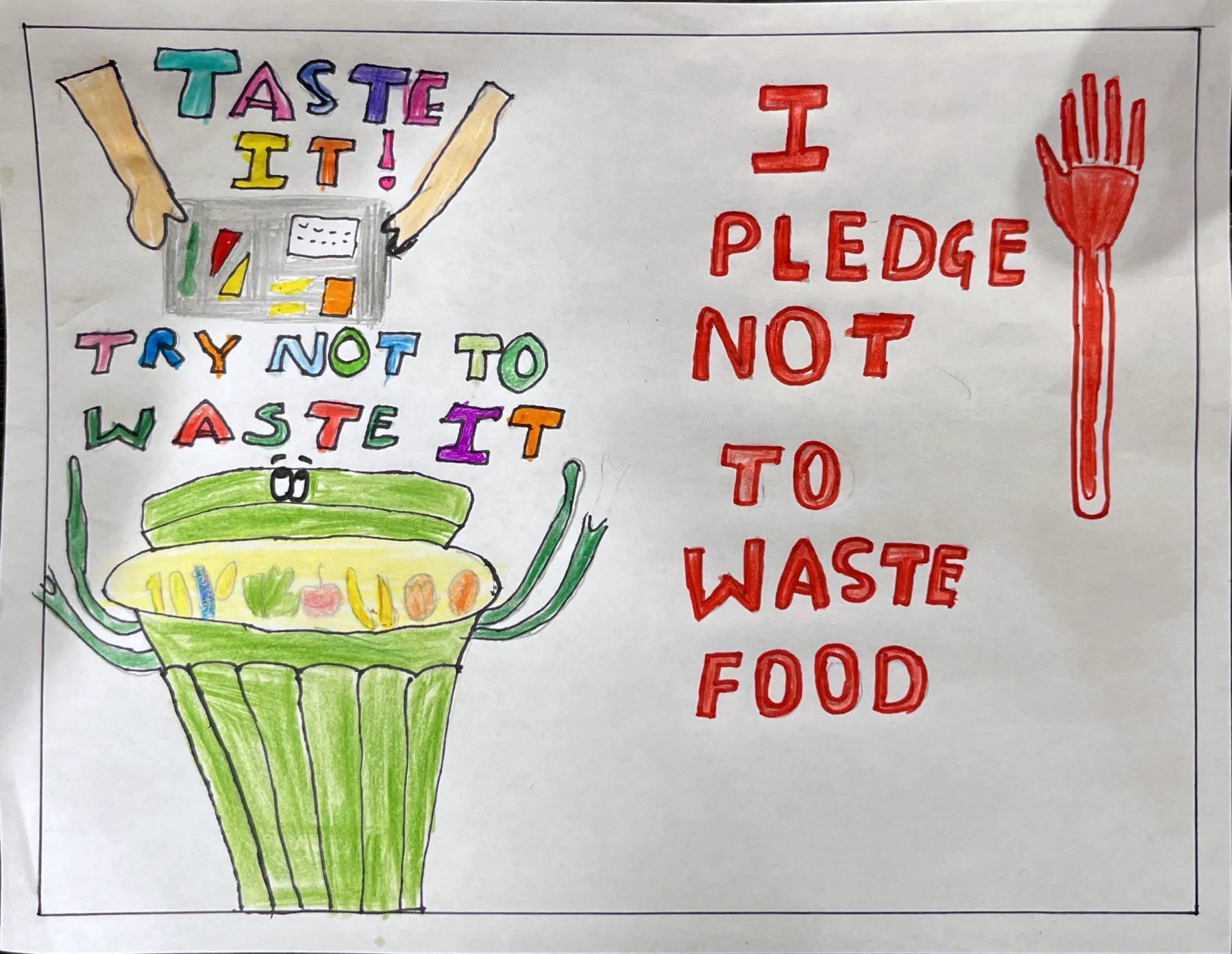 A green bin accepting food waste. A red hand with the words “I pledge not to waste food.