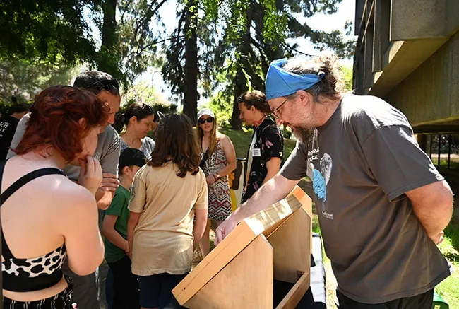 Postdoctoral researcher and arachnologist James Starrett (foreground) and doctoral student and dragonfly expert Christofer Brothers (background) talk to visitors about the insect specimens. (Photo by Kathy Keatley Garvey)