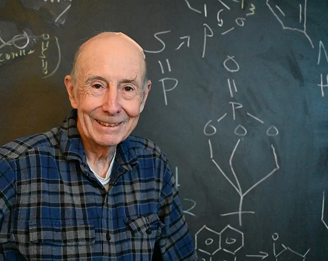 Bruce Hammock, shown in front of a blackboard in his office, "is undeniably a giant in the field of science. However, what truly sets him apart is his unwavering commitment to student mentoring, his devoted care for group members, and his exemplary role as a model for training the next generation of scientists,” says Hammock lab alumnus Guodong Zhang, now an assistant professor in the UC Davis Department of Nutrition. (Photo by Kathy Keatley Garvey)