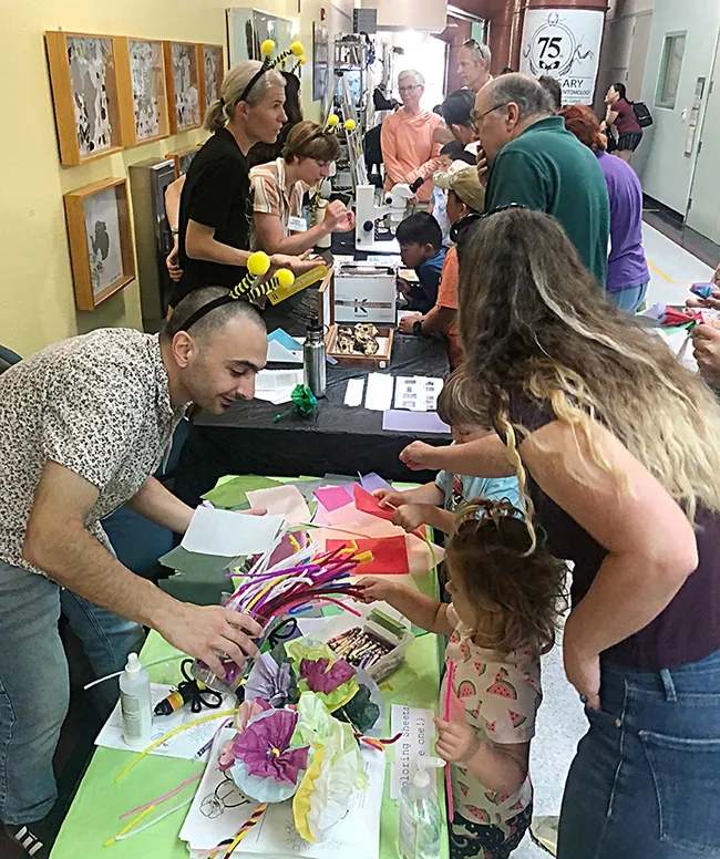 The Rachel Vannette lab engages the crowd at the Bohart Museum open house. In front, from back, are doctoral student Dino Sbardellati, associate professor Rachel Vannette, junior specialist Leta Landucci and doctoral candidate Lexie Martin. (Photo by Kathy Keatley Garvey)