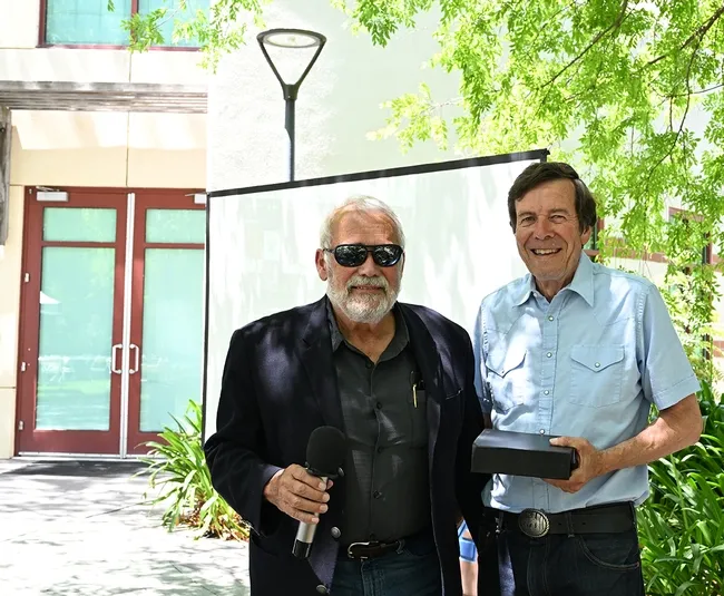 UC Davis distinguished emeritus professor Frank Zalom (right) pays tribute to UC Davis distinguished professor James R. Carey. (Photo by Kathy Keatley Garvey)