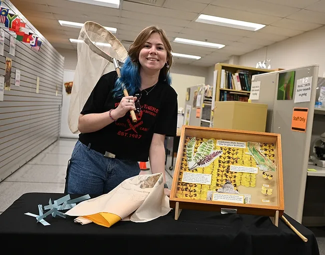 UC Davis psychology major Naomi Lila, a member of the UC Davis Entomology Club, awaits visitors. (Photo by Kathy Keatley Garvey)