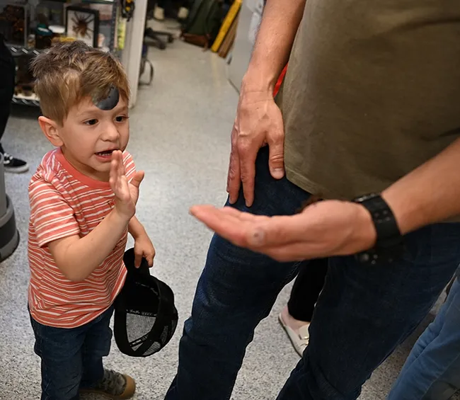 Sebastian Carrasco, 3, waves "bye bye" to a stick insect. He decided he didn't want to hold it. (Photo by Kathy Keatley Garvey)