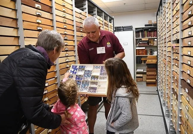 Jeff Smith, curator of the Bohart Museum of Entomology's Lepidoptera collection, chats with visitors at an open house. (Photo by Kathy Keatley Garvey)