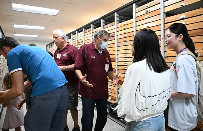 Jeff Smith (left), curator of the Lepidoptera collection at the Bohart Museum, and Bohart associate Greg Kareofelas talk to open house attendees and show moth specimens. (Photo by Kathy Keatley Garvey)