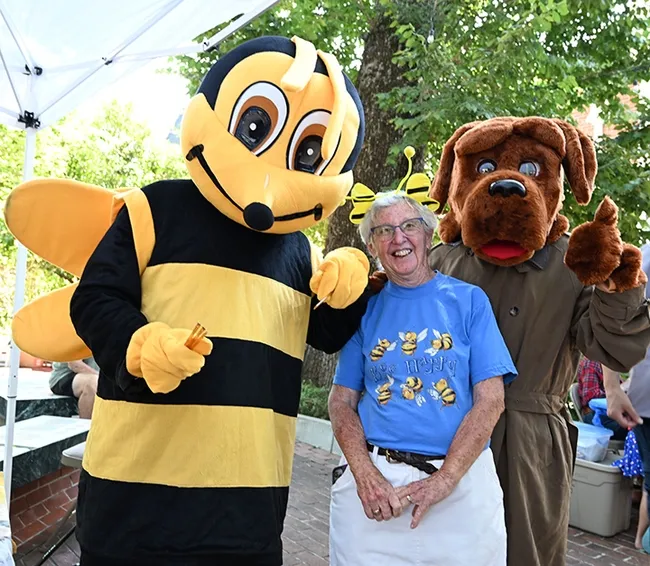 The Honey Bee poses with "Queen Bee" Ettamarie Peterson of Petaluma, who displayed her bee observation hive at the event. At right is a costumed McGruff the Crime Dog from the Vacaville Police Department. (Photo by Kathy Keatley Garvey)