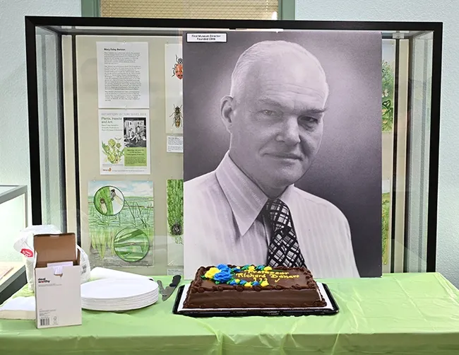 A portrait of Richard "Doc" Bohart graces a wall overlooking a celebratory cake at the Bohart Museum of Entomology's Sept. 28th open house. "Doc" was born Sept. 28, 2013 in Palo Alto and founded the UC Davis insect museum, now known as the Bohart Museum of Entomology. (Photo by Kathy Keatley Garvey)