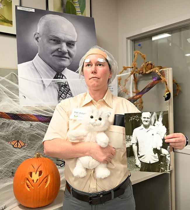 Tabatha Yang, education and outreach coordinator of the Bohart Museum of Entomology, strikes a pose as "Doc" Bohart at the Bohart Museum Society's Halloween party. (Photo by Kathy Keatley Garvey)