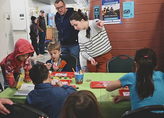 Entomologist Riley Hoffman at the maggot art table at the Bohart Museum of Entomology open house. (Photo by Kathy Keatley Garvey)