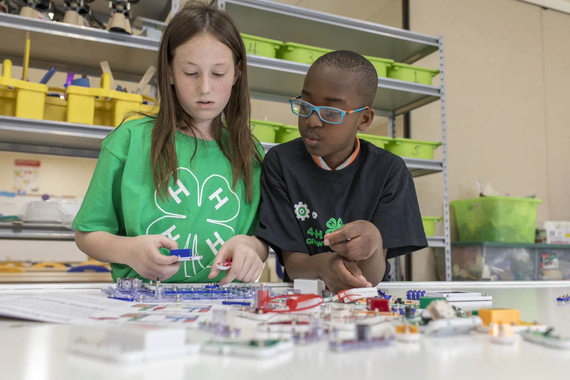 Two youth working on circuits together.