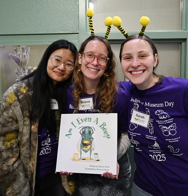 The Felicity Muth lab team of graduate students (from left) Minjung Baek, Melanie Kimball and Sarah Waybright with a copy of Muth's children's book, "Am I Even a Bee?" (Photo by Kathy Keatley Garvey)