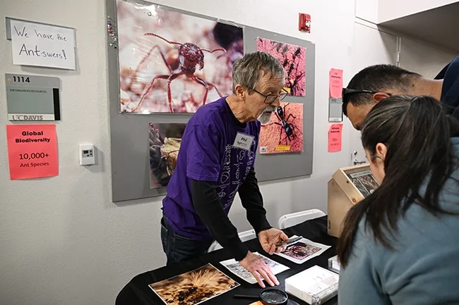 Professor Phil Ward, an ant specialist with the UC Davis Department of Entomology, responds to a question below a sign that reads "We have the Antswers." (Photo by Kathy Keatley Garvey)