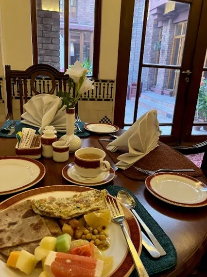 Pakistani breakfast with chickpeas, fruit, tea