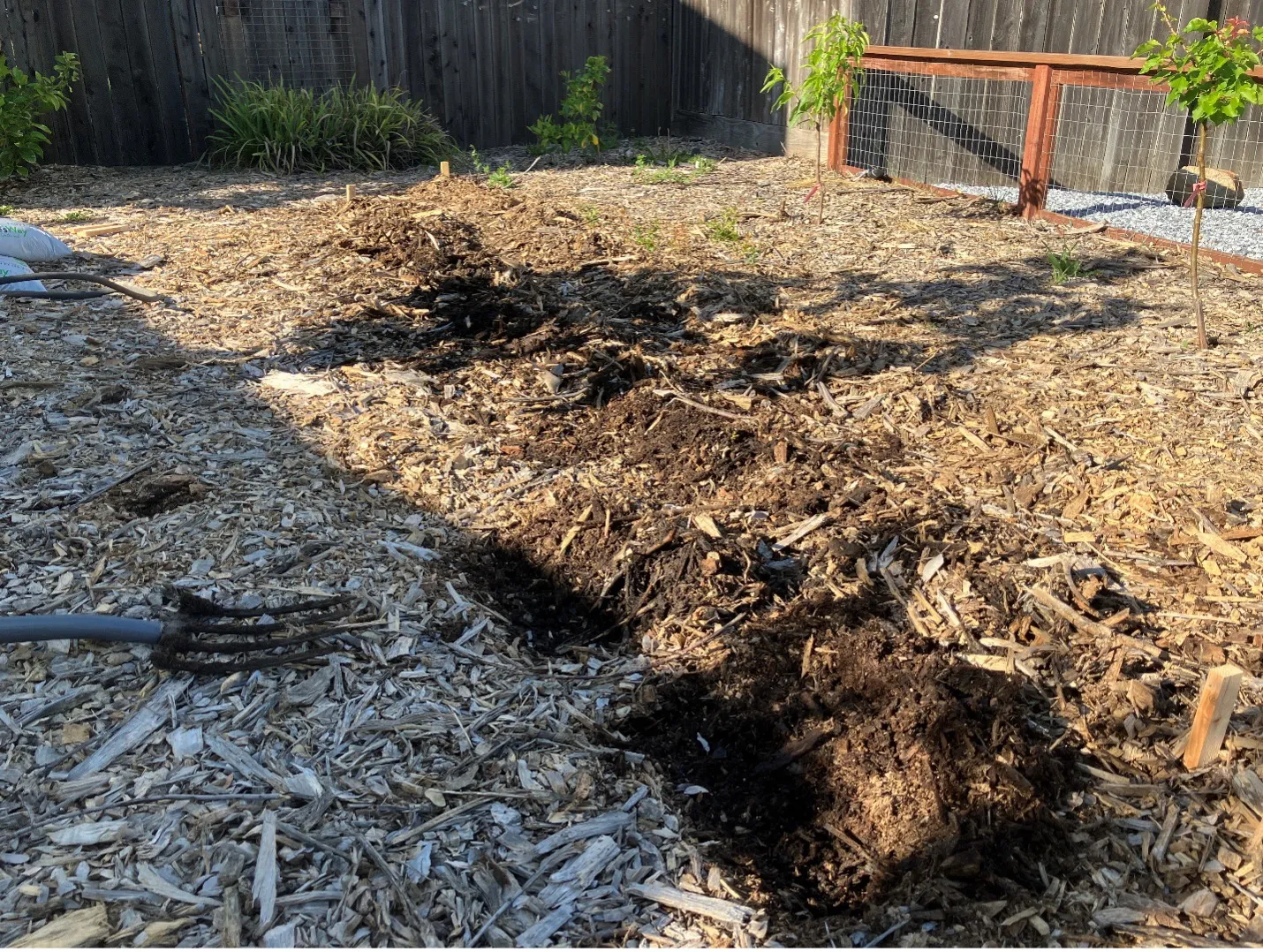 ground that has been turned over by pitchfork nearby