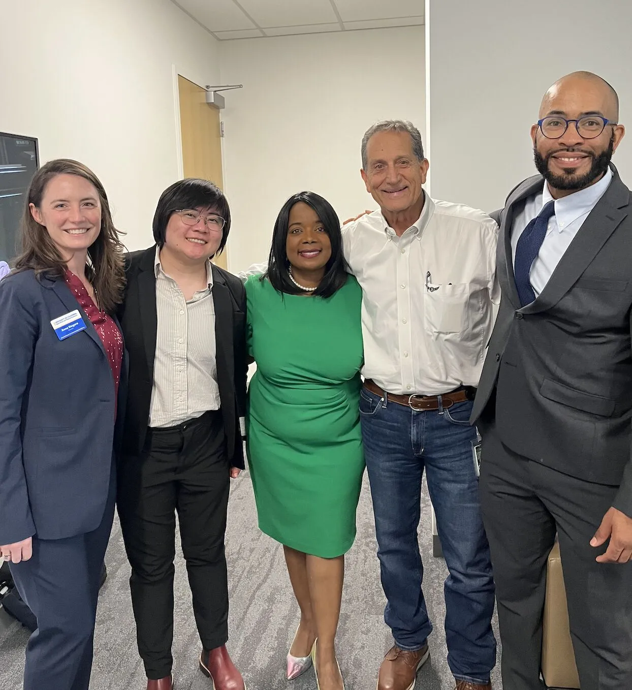 Five people standing in a row.