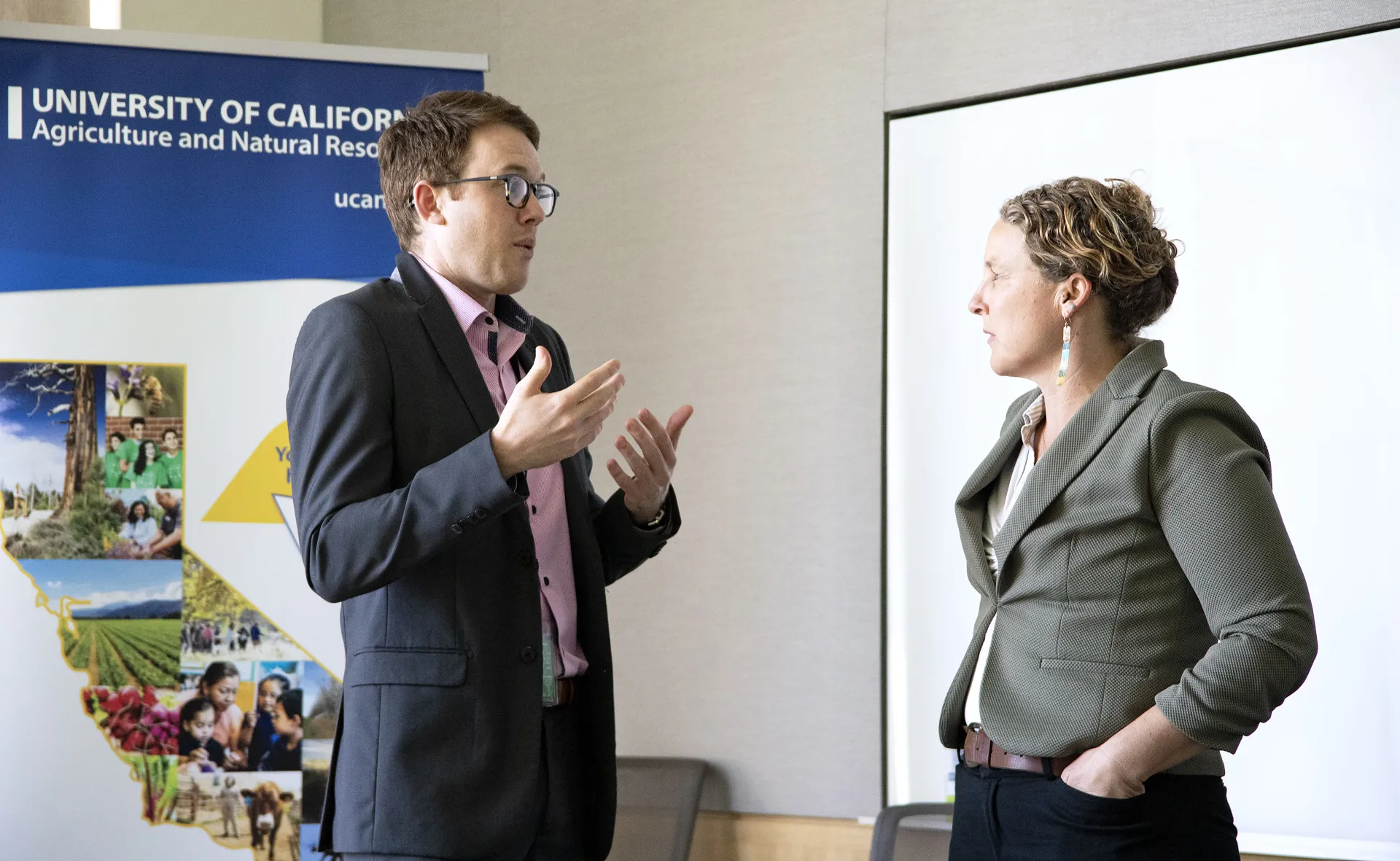 Lenya Quinn-Davidson at right talks with a legislative aide
