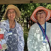 Two master gardeners at an event booth