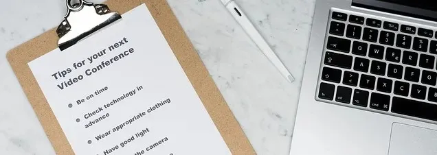 Presentation checklist next to an open laptop on a desk.