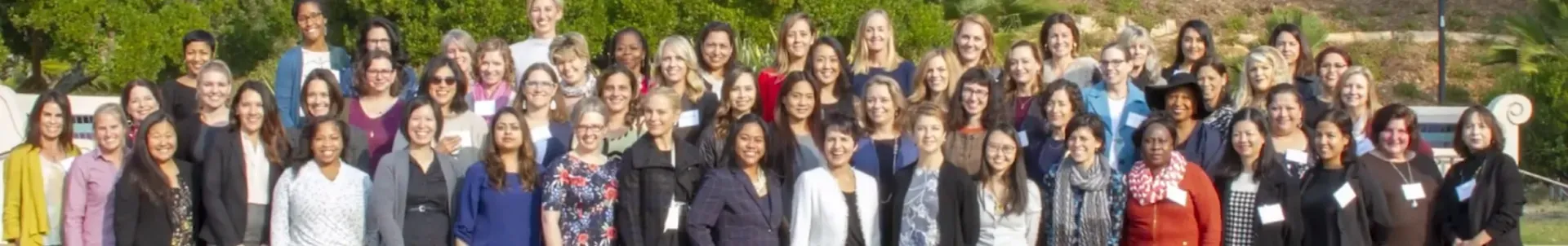 Large group of employees smiling together for a group photo.