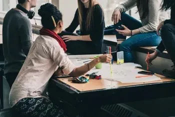 Group of employees planning at a desk.