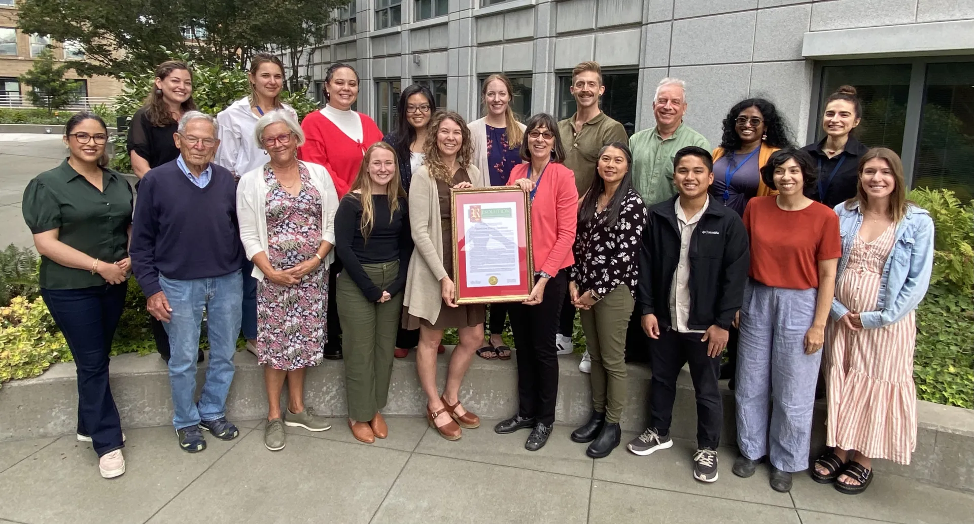 Nutrition Policy Institute team celebrates with a resolution recognizing their achievements