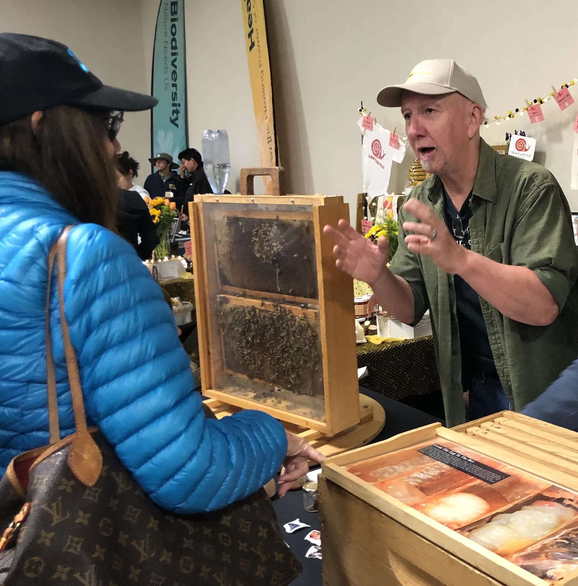 Beekeeper Rick Moehrke, a retired Vacaville teacher, talks to a visitor at a California Honey Festival. (Photo by Kathy Keatley Garvey)