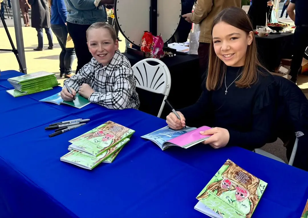 Josiah and Jayna signing the Imagine This... books at Ag Day