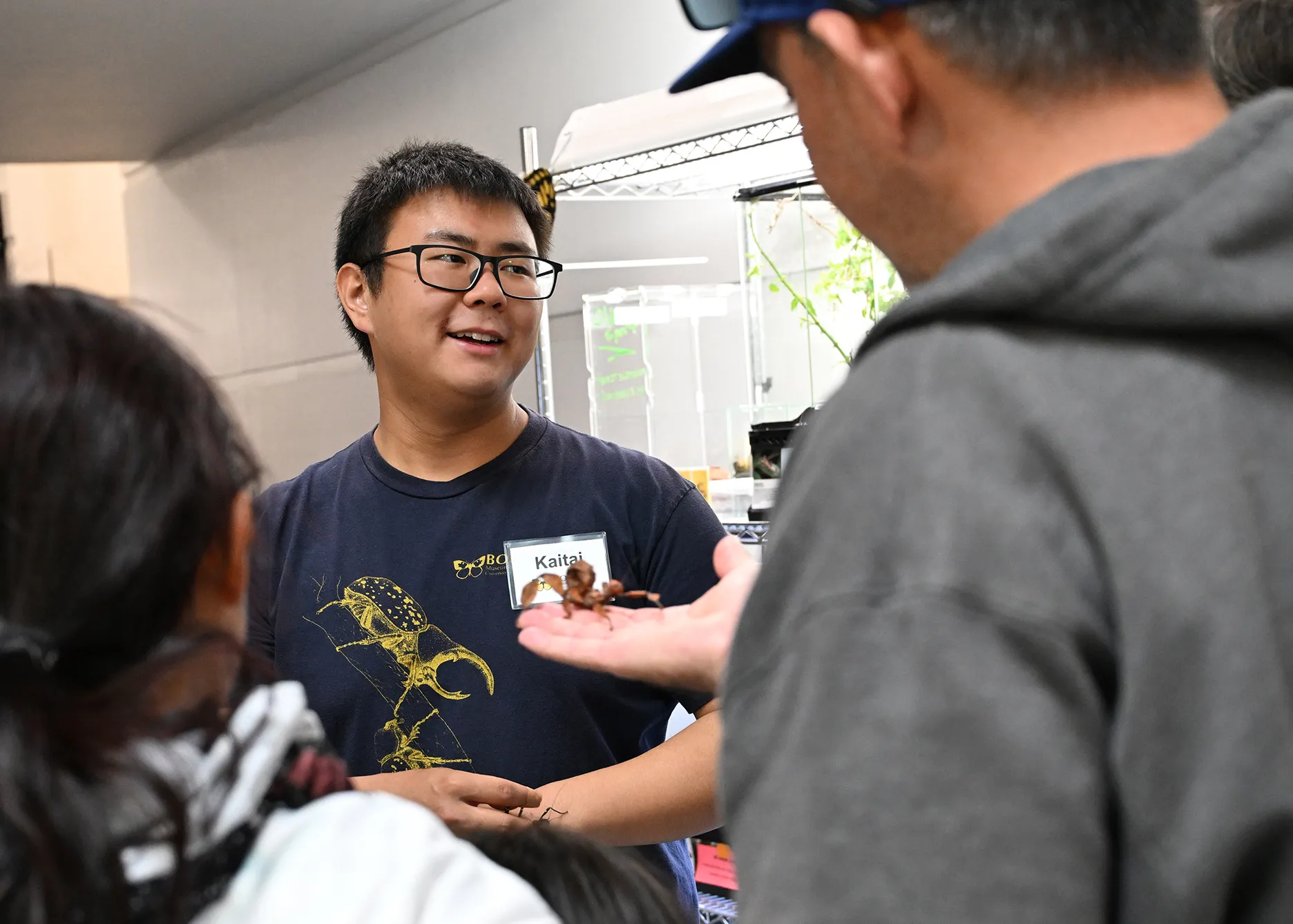 Kaitai Liu, a senior majoring in entomology at UC Davis, chats with visitors at the Bohart Museum petting zoo. (Photo by Kathy Keatley Garvey)