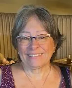 Maria Giovanni has short gray hair and clear glasses.